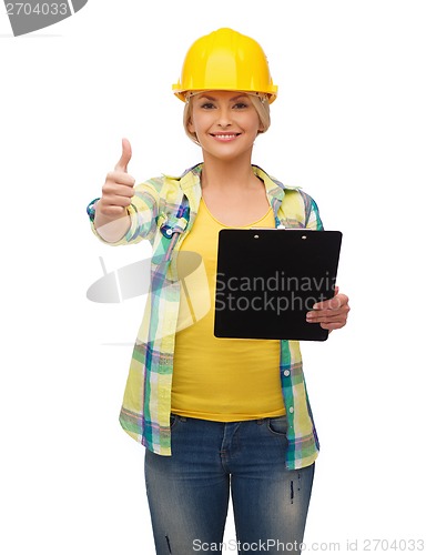 Image of smiling woman in helmet with clipboard