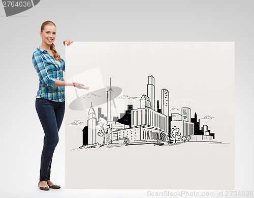Image of smiling young woman with board and city drawing