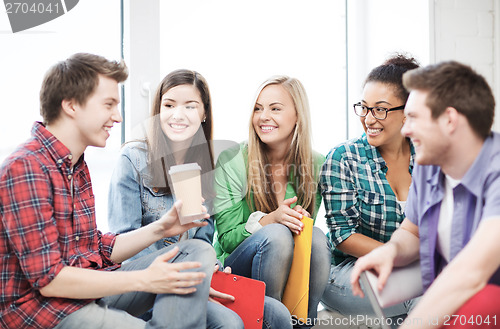 Image of students communicating and laughing at school