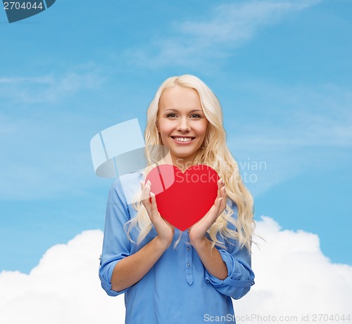 Image of smiling woman with red heart