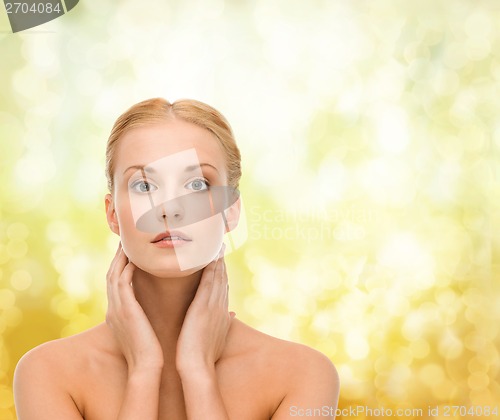 Image of beautiful woman touching her face skin