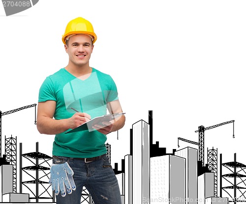 Image of smiling man in helmet with clipboard