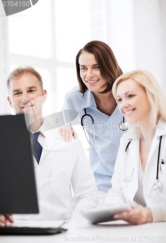 Image of doctors looking at computer on meeting