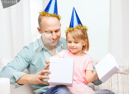 Image of father and daughter in blue hats with gift box