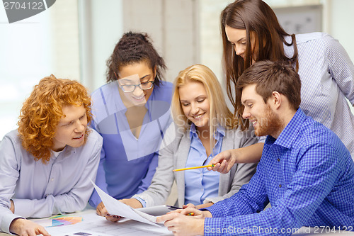 Image of smiling team with color samples at office