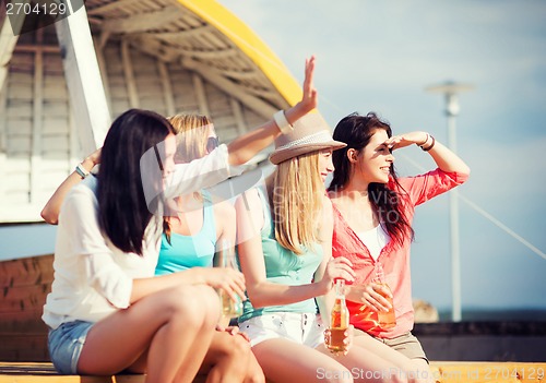 Image of girls with drinks on the beach