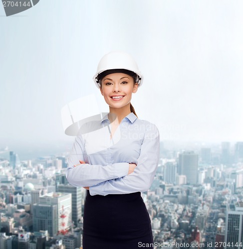 Image of friendly smiling businesswoman in white helmet