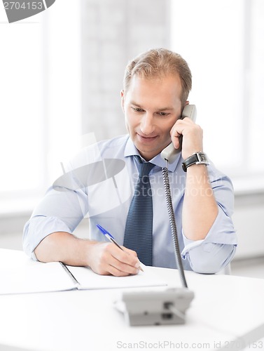 Image of handsome businessman talking on the phone