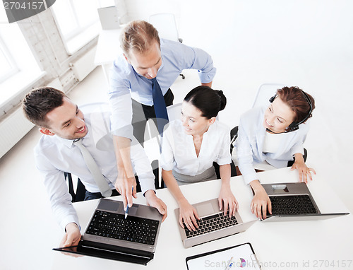 Image of group of people working in call center