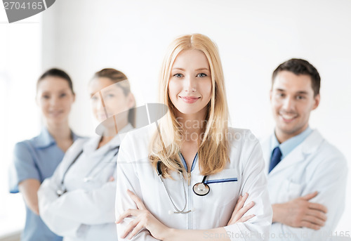 Image of female doctor in front of medical group