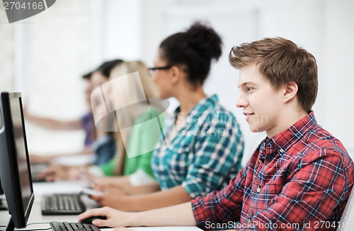 Image of student with computer studying at school