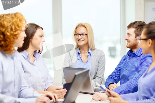 Image of smiling team with laptop and table pc computers