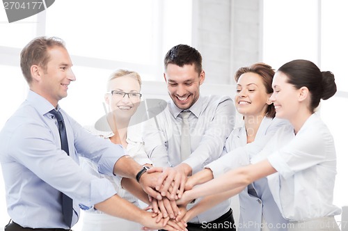 Image of business team celebrating victory in office
