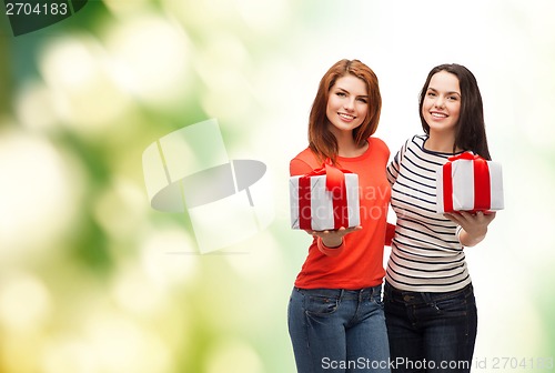 Image of two smiling teenage girls with presents