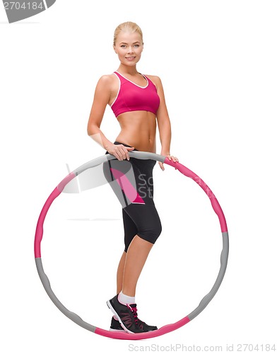 Image of young sporty woman with hula hoop