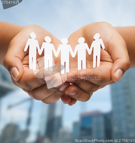 Image of womans hands with paper team