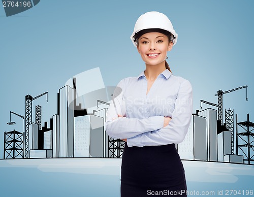 Image of friendly smiling businesswoman in white helmet