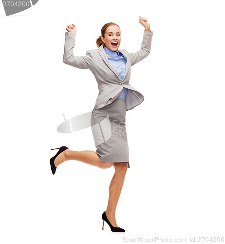 Image of happy woman jumping with hands up