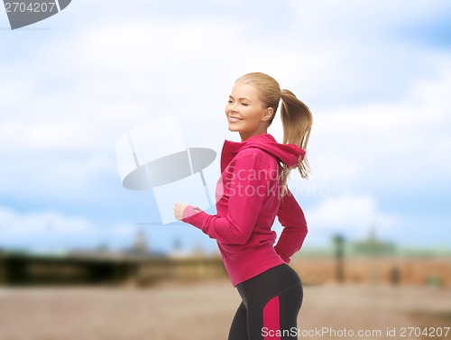Image of sporty woman running or jumping