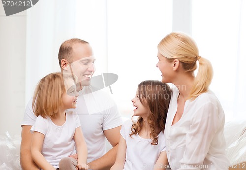Image of smiling family with two little girls at home