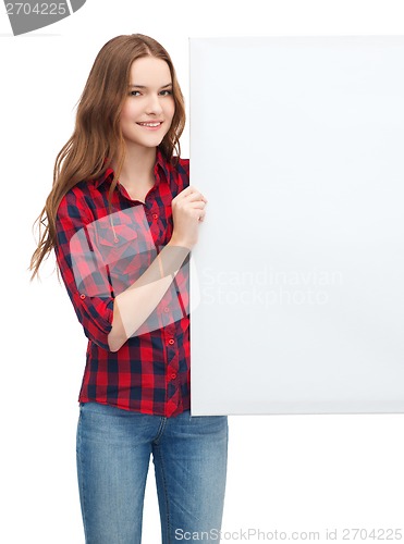 Image of smiling young teenage girl with white blank board