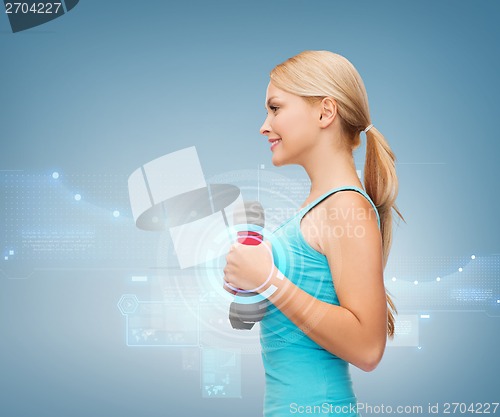 Image of young sporty woman with light dumbbells