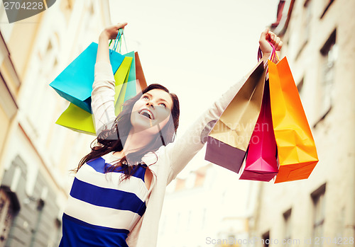 Image of woman with shopping bags in city