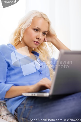 Image of woman with laptop computer at home