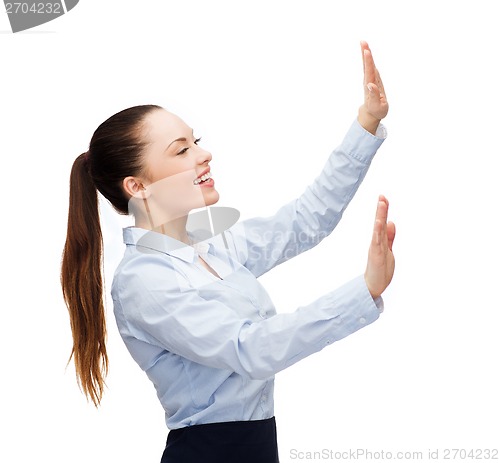 Image of smiling businesswoman pointing to something