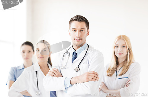 Image of male doctor in front of medical group