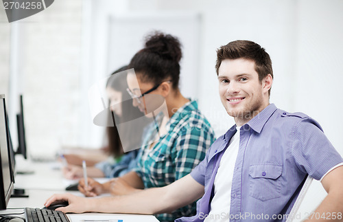 Image of student with computer studying at school