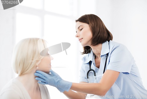 Image of plastic surgeon or doctor with patient