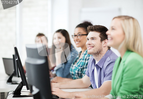 Image of students with computers studying at school