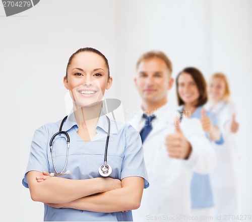 Image of smiling female doctor or nurse with stethoscope