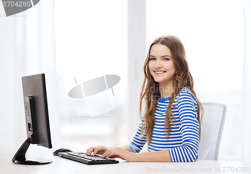 Image of dreaming teenage girl with computer at home