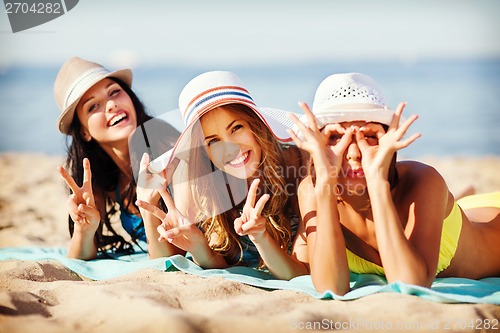 Image of girls sunbathing on the beach