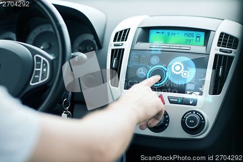 Image of man using car control panel