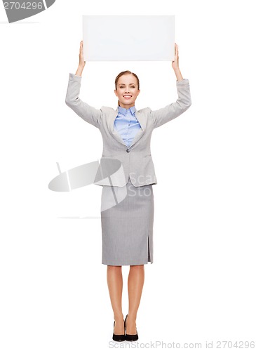 Image of smiling businesswoman with white blank board