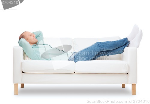 Image of smiling man lying on sofa