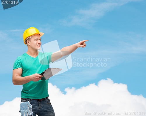 Image of smiling man in helmet with clipboard