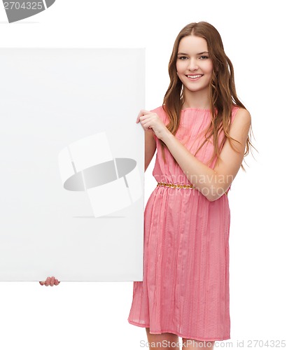 Image of young woman in dress with white blank board