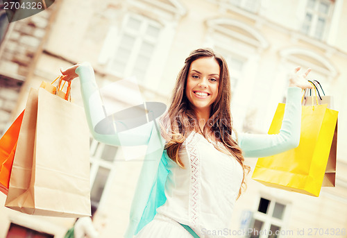 Image of woman with shopping bags in city