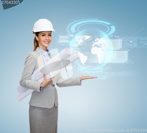 Image of smiling architect in white helmet with blueprints