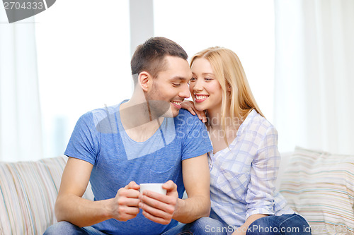 Image of smiling man with cup of tea or coffee with wife