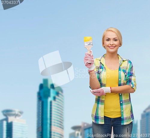 Image of smiling woman with paintbrush