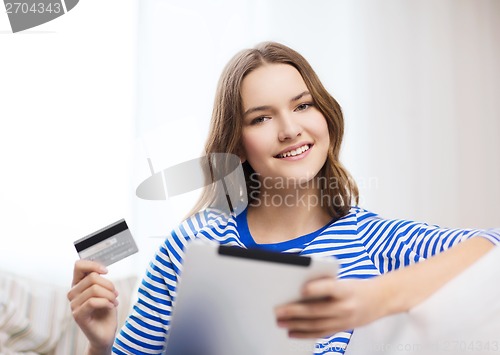 Image of smiling girl with tablet pc and credit card
