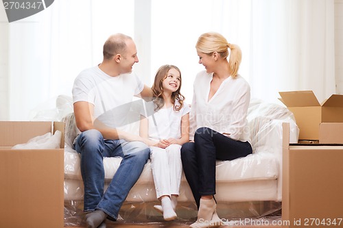 Image of smiling parents and little girl at new home