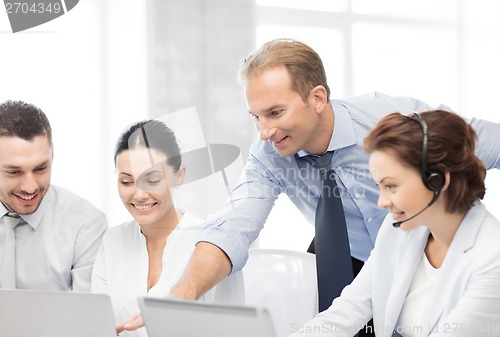 Image of group of people working in call center