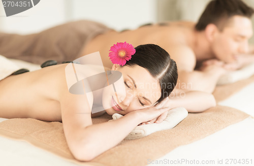 Image of couple in spa with hot stones
