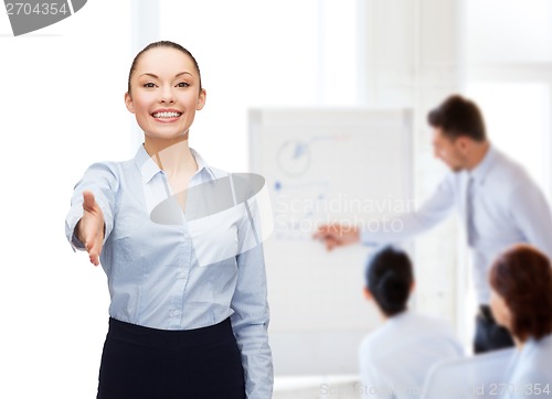 Image of businesswoman with opened hand ready for handshake